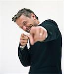 Studio portrait of businessman pointing