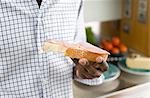 Young man holding sandwich