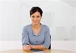 Portrait of smiling businesswoman sitting in office