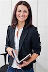 Happy businesswoman portrayed in office environment