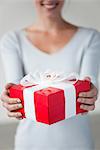 Woman holding gift box, cropped