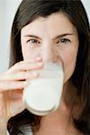 Mid-adult woman drinking glass of milk