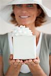 Woman holding out wrapped gift