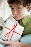 Preteen boy holding gifts