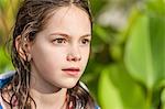 Girl with wet hair looking away in interest