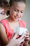 Girl receiving gift, cropped