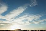 Sun setting over distant skyline of Paris, France