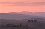 A view at dawn toward Pennella a stone farmhouse in the Val d'Orcia, UNESCO World Heritage Site, Tuscany, Italy, Europe