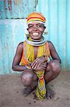 Bonda tribeswoman, smiling, wearing traditional bead costume with beaded cap, earrings and metal necklaces at weekly market, Rayagader, Orissa, India, Asia