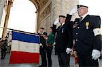 French Muslim girl scout and war veterans at the Arc de Triomphe, Paris, France, Europe