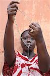 African woman praying the rosary, Lome, Togo, West Africa, Africa