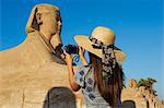 Tourist taking a photo on the Sphinx path, Temple of Luxor, Luxor, Thebes, UNESCO World Heritage Site, Egypt, North Africa, Africa