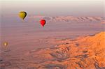 Hot air balloons suspended over the Theban hills of Luxor and the Valley of the Queens at sunrise, Thebes, UNESCO World Heritage Site, Egypt, North Africa, Africa