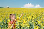 Boy playing with toy car in field