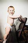 Baby girl climbing on piano