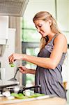 Smiling woman cooking in kitchen