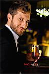 Smiling man having drink at bar