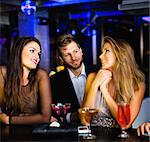 Man talking to women at bar