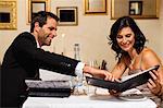 Couple examining menus in restaurant