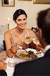 Couple toasting each other in restaurant