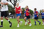 Coach training children on field