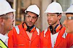 Workers walking at oil refinery