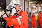 Worker with walkie talkie on site