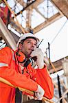 Worker with walkie talkie on site