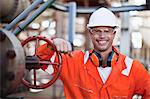 Worker smiling at oil refinery