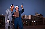 Workers talking at oil refinery