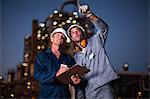 Workers talking at oil refinery