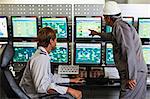 Men working in security control room