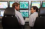 People working in security control room