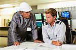 Men working in security control room