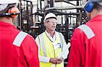 Workers talking at chemical plant