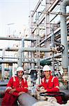 Workers talking at chemical plant