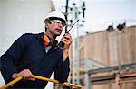 Worker using walkie talkie on site