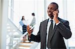 Businessman on cell phone in office