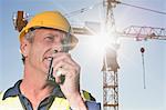 Worker using walkie talkie on site