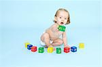 Baby girl playing with colored blocks