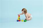 Baby girl playing with colored blocks