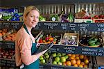 Grocer using tablet computer in store