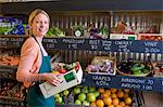 Grocer arranging produce for sale