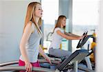 Girl using treadmill in gym