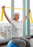 Older woman stretching in gym