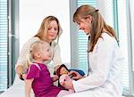 Doctor examining girls doll in office