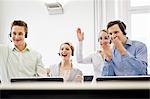 Business people cheering in headsets