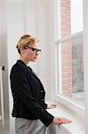 Businesswoman standing at window