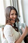 Smiling woman drinking glass of water