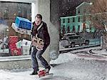 Man dropping Christmas gifts in snow